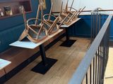 many chairs that are sitting on the benches in the room