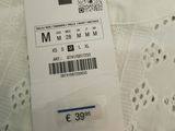 a white shirt with a price tag attached to it