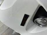 a close up of a car ' s headlight with a sticker on it