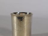 a silver cup that is sitting on a table