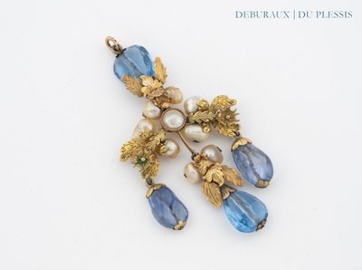 a picture of a brooch with blue and white beads