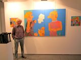 a man that is standing in front of a painting