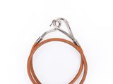 un gros plan sur une paire de bracelets en cuir sur fond blanc