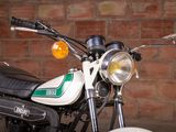 a motorcycle that is parked in front of a brick wall