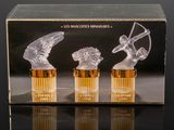 three glass figurines of a woman and a man with a bow and arrow