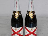 two bottles of champagne sitting on top of a marble counter top