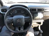 the interior of a car with a steering wheel and dashboard controls