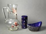 two vases and a bowl sitting next to each other on a table