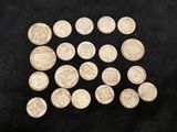 a pile of silver coins sitting on top of a black surface