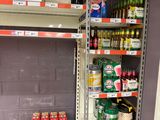 many cans of beer on the shelves in the store