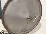 a silver plate on a table with a cord