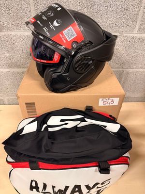 two helmets and a bag are sitting on top of a box