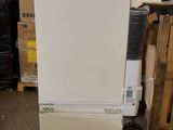 an image of a white refrigerator in a warehouse