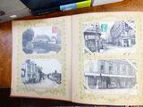 an open book on a table with pictures of old buildings