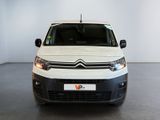 the white van is parked in a large room with a white wall
