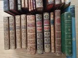a lot of old books on a shelf on the table