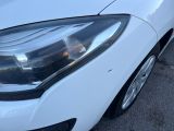 a close up of a car ' s headlight on a parking lot