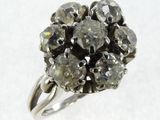 an image of a diamond cluster ring on a white surface