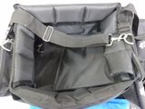 a black bag with a handle on it sitting on a blue blanket