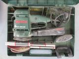 a green box with tools in it on a table
