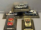 five different model cars on display in a display case