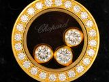 an image of a close up of a gold and diamond pendant