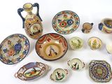 many different types of pottery on display on the table