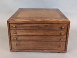 an image of a small wooden box with four drawers
