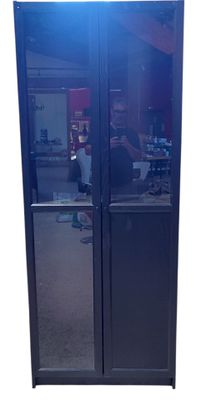 a glass door with a reflection of a person in it