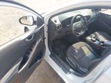 the interior of a car with the door open and the driver ' s seat down