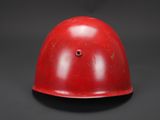 an old red helmet on a black background with a black background