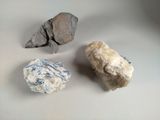 three rocks that are sitting on a table