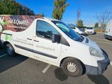a white van parked in a parking lot with other vehicles