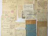 some old papers are laying on top of each other on a table