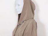 a white mannequin wearing a brown hoodedie and black pants