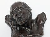statue of a woman holding her head in her hands