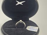 a silver ring in a black box on a white table