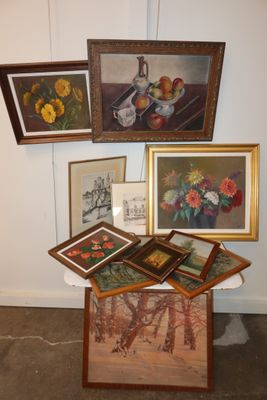 many framed pictures of flowers and fruit on a table