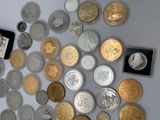 a lot of coins that are on the table