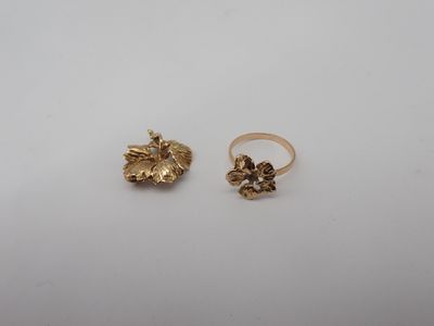 a pair of gold rings on a white surface