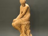 an image of a statue of a woman sitting on a pedestal