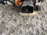 a close up of a chainsaw on a concrete surface