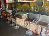 three stools that are sitting in front of a brick wall