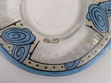 a glass plate with a design on it on a table