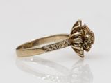 an image of a gold ring with a flower design