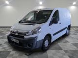 the white van is parked on a checkered floor in a room