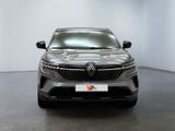 the front view of a grey car in a white room