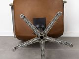 an image of a brown leather chair with a metal base