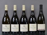 six bottles of wine are lined up in a row on a table