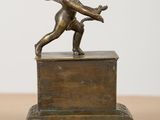 an image of a bronze statue of a cupid holding a bow